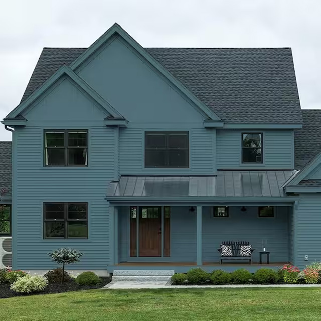 Màu xanh khói kết hợp cùng gạch xám giúp ngoại thất công trình