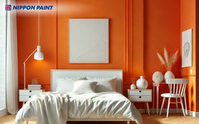 Sơn tường màu cam đậm kết hợp nội thất trung tính giúp phòng ngủ vừa rực rỡ vừa hài hòa