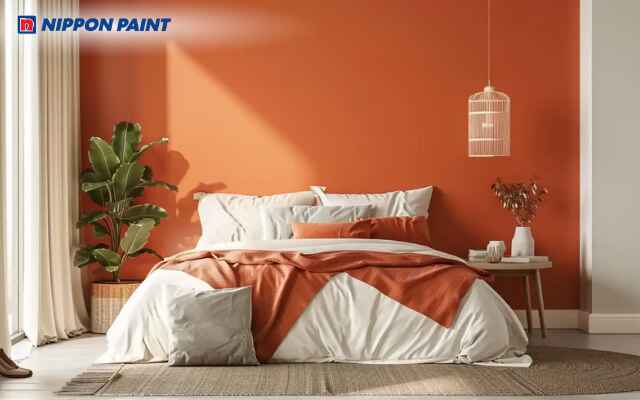 Sơn tường phòng ngủ cam trung tính kết hợp thảm và gối tone be, hài hòa tinh tế