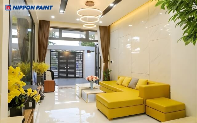 Phòng khách phối màu vàng nhạt trên rèm cửa, sofa, tạo cảm giác ấm áp và thân thiện